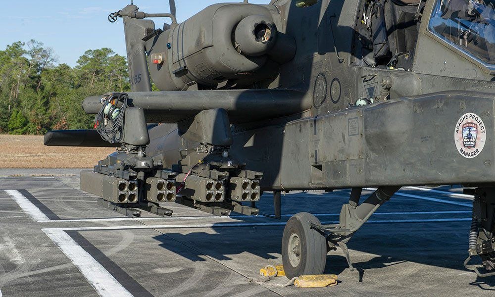 Apache helicopter shown with capacity for 32 laser‑guided rockets